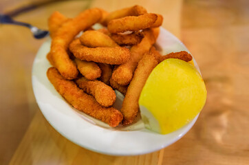 Spanish pintxos fried calamari in a bar in San Sebastian, Basque Country, Spain