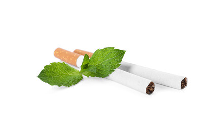 Menthol cigarettes and fresh mint leaves on white background