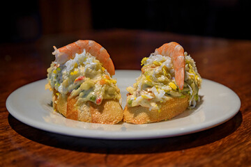Spanish pintxos Russian salad with shrimp in a Basque bar, San Sebastian, Spain