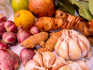 Various kinds herbs and spices. Fresh Onions, garlic, turmeric, galangal, Bay leaf, lime. as a kitchen spice