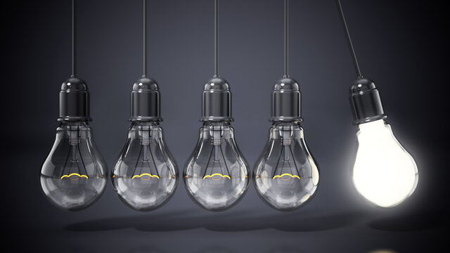 Lit lightbulb stands out among lightbulbs in a row. 3D illustration
