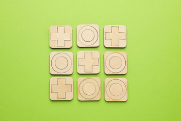 Tic tac toe set on light green background, flat lay