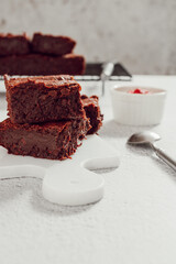 chocolate brownie on a white marble serving board