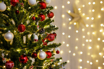 decorated Christmas tree with colorful baubles and copy space over festive led lights