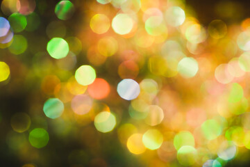 Obraz premium Beautiful natural bokeh of the colorful lights. Abstract Christmas New Year backdrop for text or advertising. Template for banner or party invitation