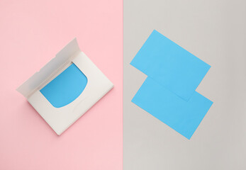 Fototapeta premium Package with facial oil blotting tissues on color background, flat lay. Mattifying wipes