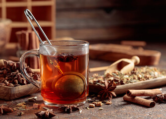 Herbal tea with spices in wooden dishes.