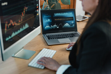 Crop trader at table with laptop and computer screen