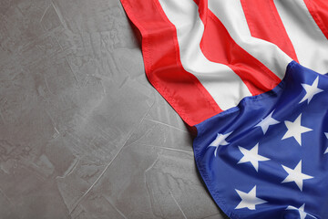 American flag on light grey background, top view. Space for text