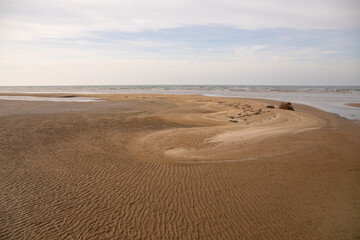 Fototapeta na wymiar Beautiful ribbed sand by the sea.