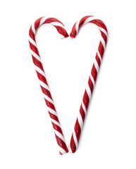 Heart made of Christmas candy canes on white background, top view