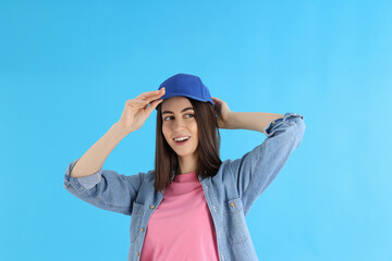 Attractive girl in cap on blue background