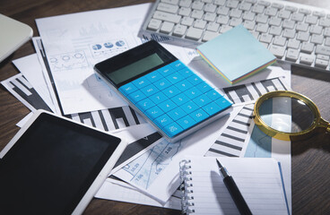 Business graphs, calculator, computer keyboard, pen, tablet, notepad, magnifying glass. Business. Analysis. Accounting