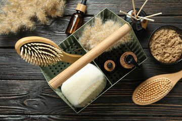 Concept of gift with basket of cosmetics on wooden background