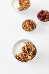 A healthy breakfast of cereals, nuts and raisins. Yogurt.