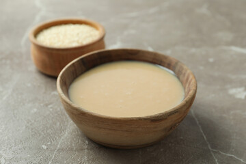 Concept of tasty food with tahini sauce on beige textured background