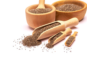 Wooden scoop of organic natural chia seeds close-up isolated on white background