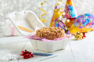 Small cake with peanuts in a box.