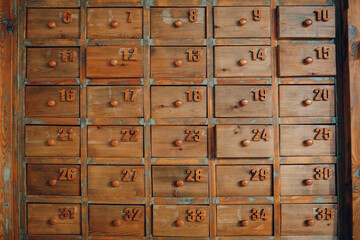 Background texture wallpaper old vintage wooden cabinet with lockers drawers file boxes. - obrazy, fototapety, plakaty