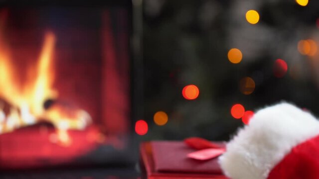 Christmas Tree with Decorations and Gifts Near a Fireplace with Lights
