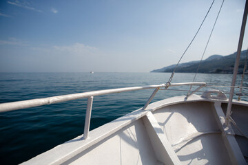 Railing in a white boat floating on the sea