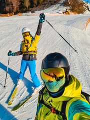 couple taking selfie at ski resort slope