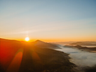 Fototapeta na wymiar aerial view of sunrise above mountain range