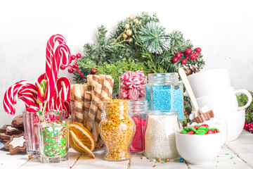 Christmas hot chocolate party bar, winter cocoa buffet with a lot of hot chocolate mugs, various topping, sprinkles, sweet appetizers