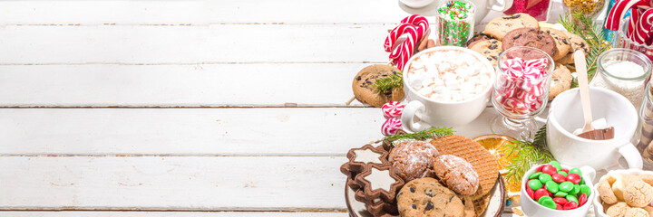 Christmas hot chocolate party bar, winter cocoa buffet with a lot of hot chocolate mugs, various topping, sprinkles, sweet appetizers