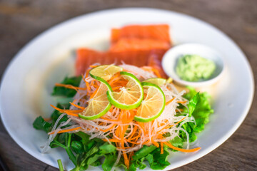 Blurred abstract background of hands eating on a table like seafood (Baked shrimp vermicelli, deep fried sea bass with fish sauce, yum squid) eaten alongside soft drinks, while on vacation with family
