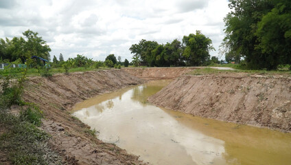 Dredged water canal for irrigation development  in rainy season in Thailand                               