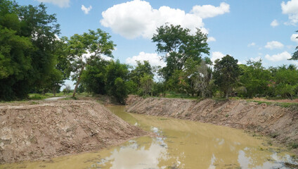 Dredged water canal for irrigation development  in rainy season in Thailand                               