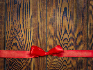 wooden brown boards tied with a red ribbon with a bow