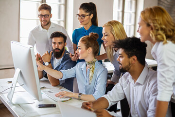 Group of happy multiethnic business people cooperating, working on meeting in corporate office