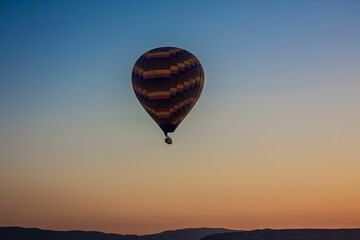Hot air balloons flying over the valley at Cappadocia, Turkey. G