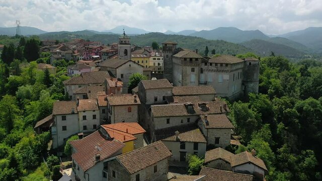 Aerial view over the Lerma Castle and town, in Piedmont, Italy - rising, drone shot