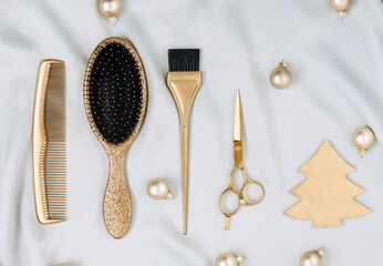 Hairdressing tools of golden color with a Christmas tree on a woven material. A template with...