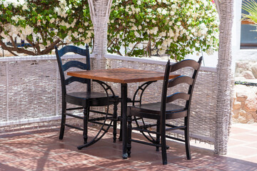 Wooden table and chairs in beach cafe next to the red sea in Sharm el Sheikh, Egypt