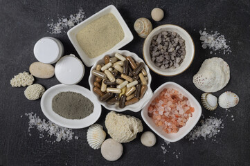 Fototapeta na wymiar Dietary supplements in capsules, various crystals of salt and sea minerals in plates