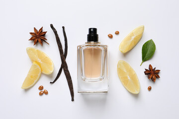 Flat lay composition with bottle of perfume, spices and lemon on white background