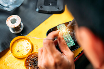 Chang repairing electrical appliances