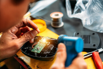 Chang repairing electrical appliances