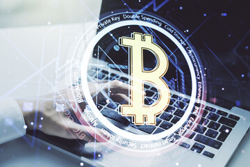 Creative Bitcoin concept with hands typing on computer keyboard on background. Double exposure