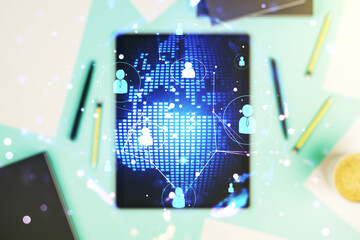 Fototapeta premium Social network media concept with world map and modern digital tablet on desktop on background, top view. Double exposure