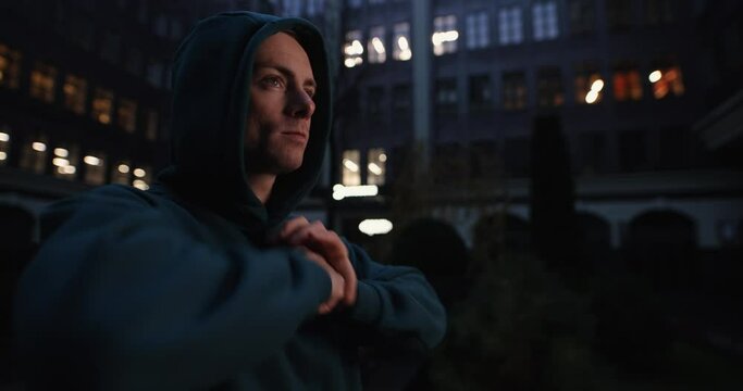 Man makes warm up his hands before street fight at night city