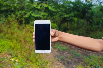 Indian school boy showing smartphone screen. online education concept.