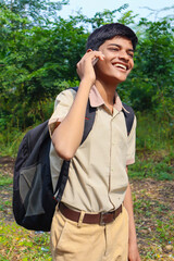 Indian school boy talking on smartphone