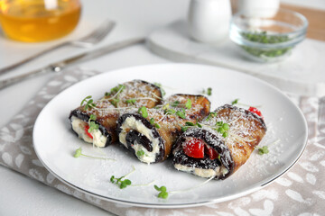 Delicious baked eggplant rolls served on white table