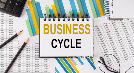 Closeup a notebook with text BUSINESS CYCLE , business concept image on chart background