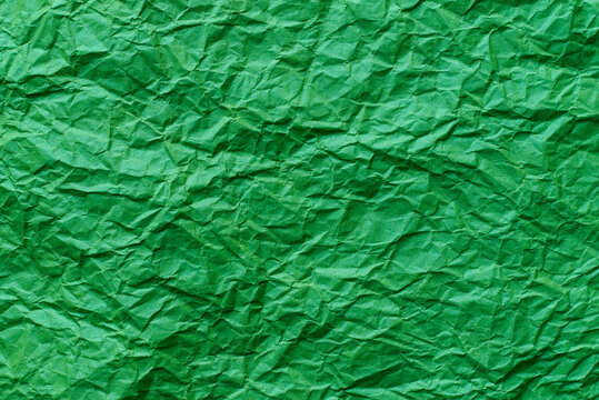 Crumpled green paper texture as a background.